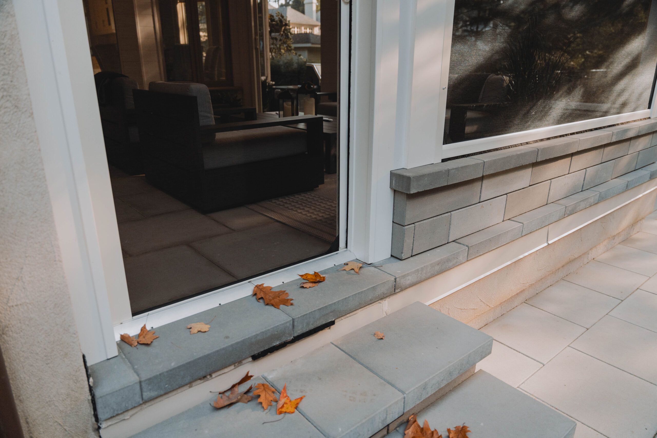 Phantom Screens on a single door entrance showing up the detail of fall leaves on the outside of the home while inside remains clean