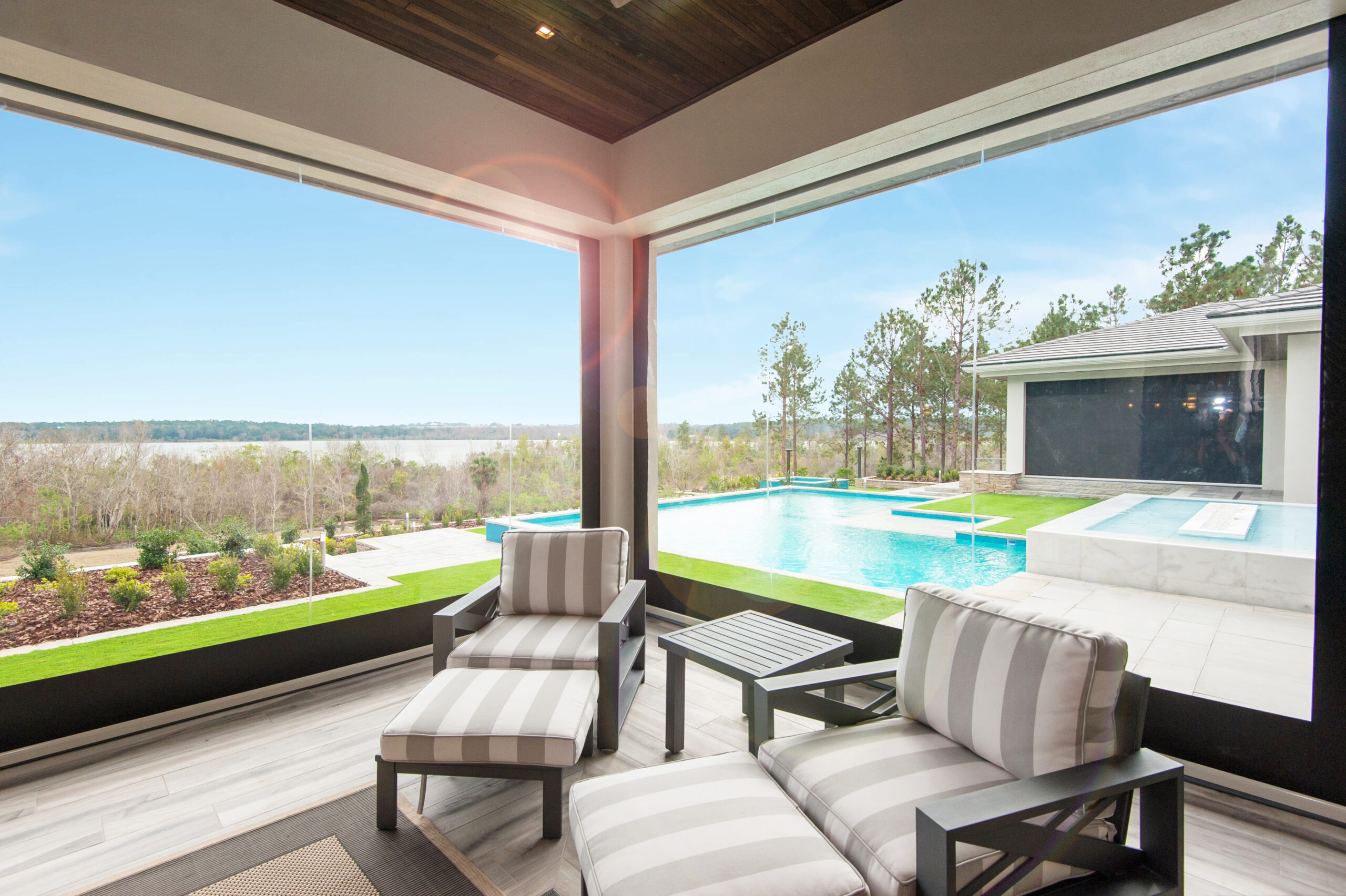 A comfortable sunroom protected with Phantom retractable clear vinyl screens.